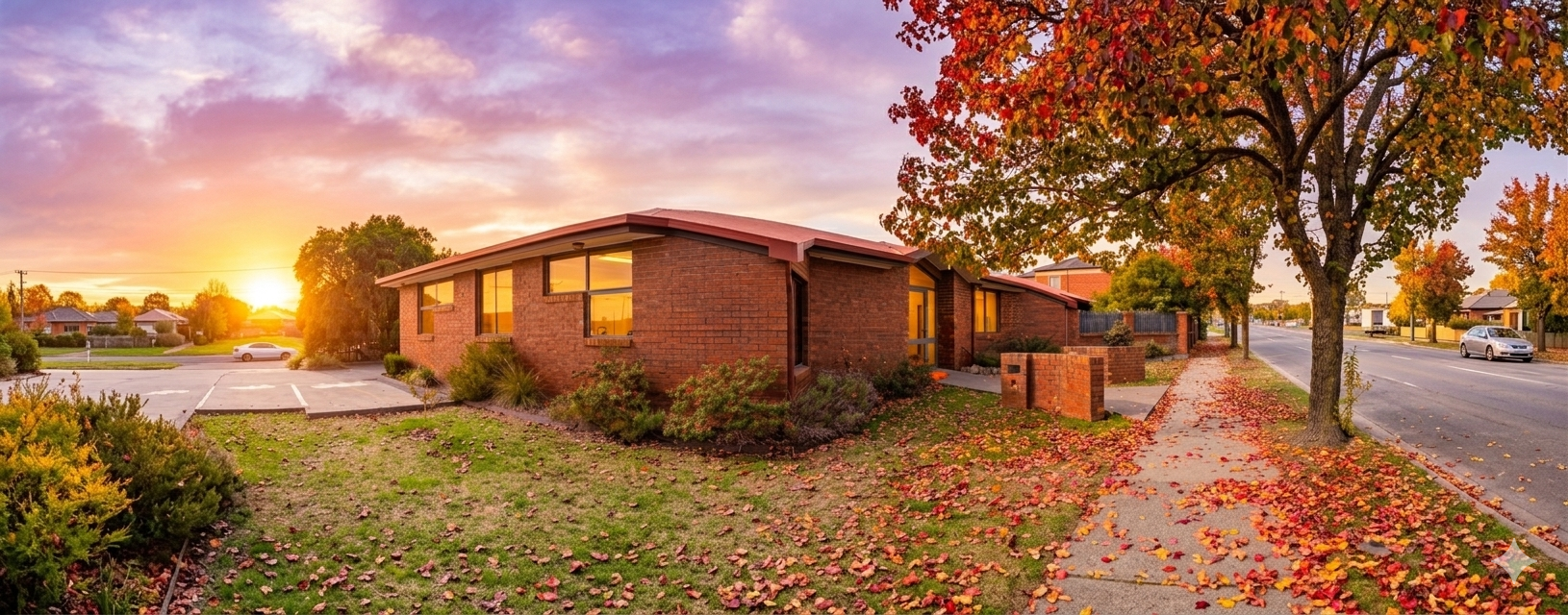 Manningham After-hours Emergency Care clinic exterior at sunset with autumn leaves on the footpath